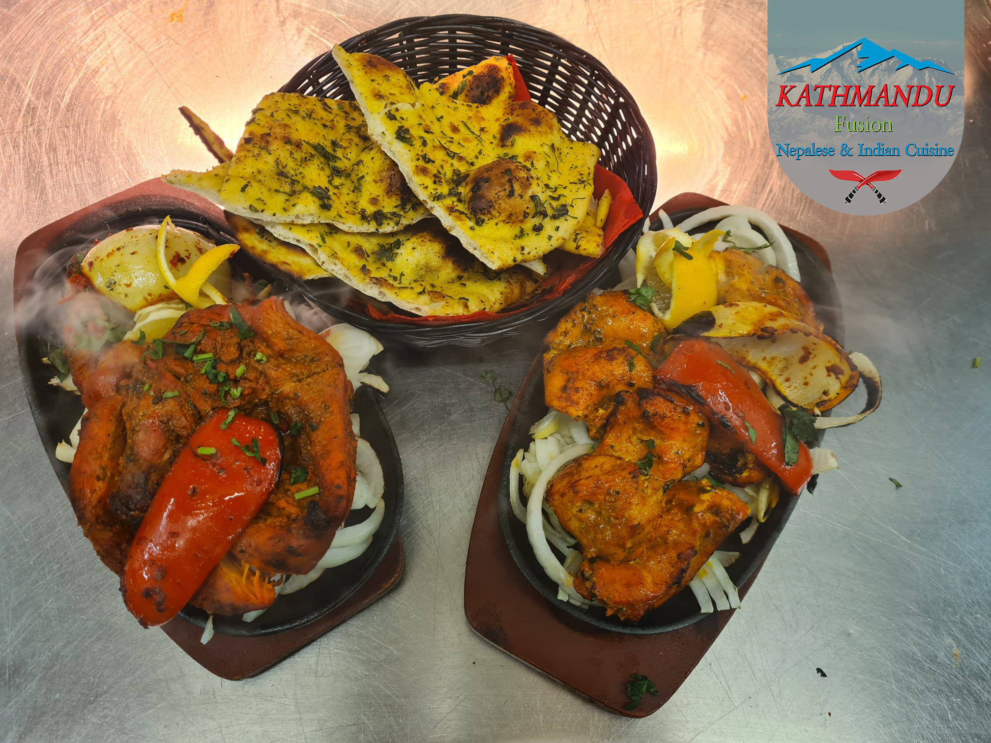  chicken biryani on a plate with salad and a curry pot with bread on 
table at Kathmandu Fusion Restaurant Glasgow